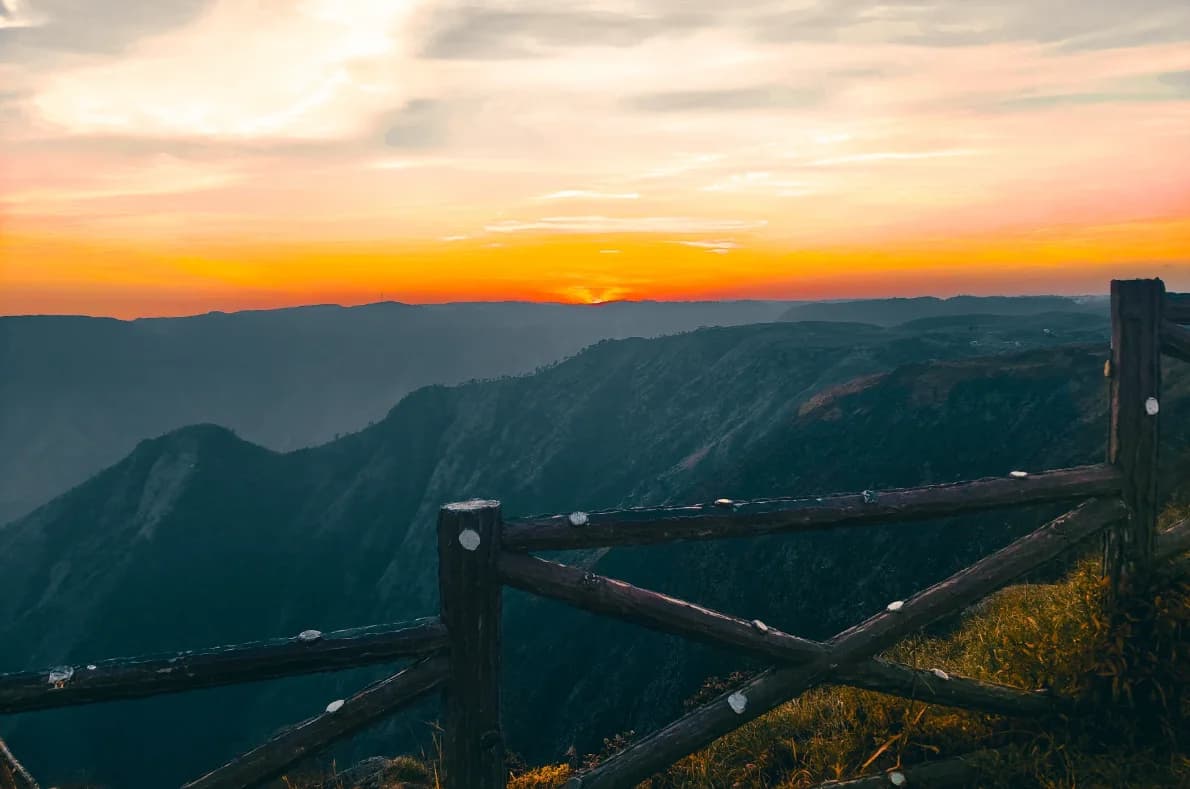 Orange sunset over Laitlum hills with a wooden fence in the foreground
